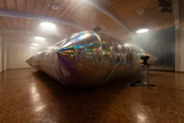 a big exhibition hall filled with an inflatable that is an artwork by the artist Jacqueline hen 