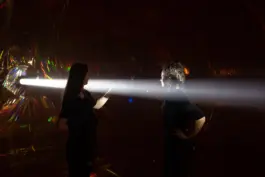 Two women standing inside an immersive light art installation by the artist jacqueline hen 